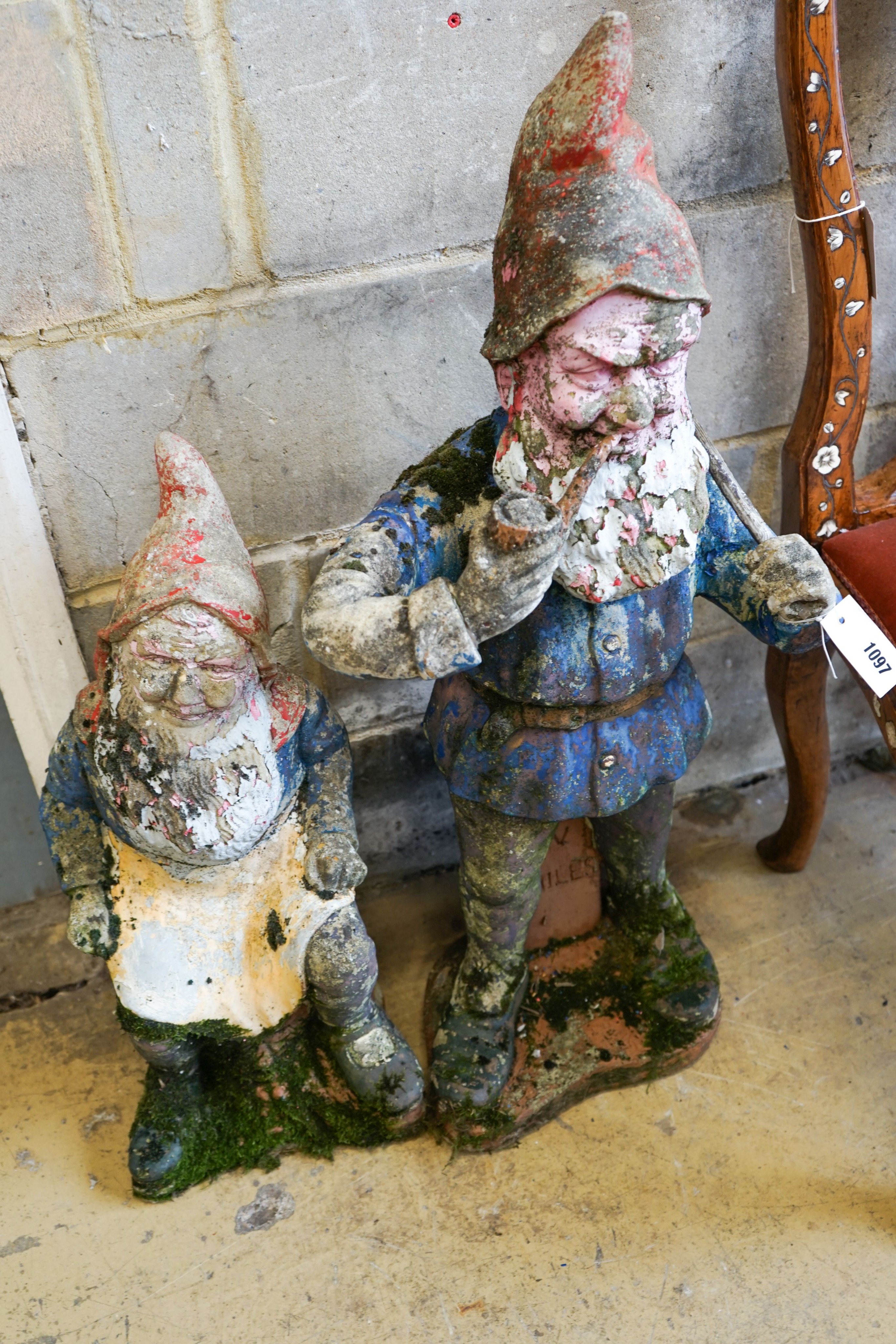 Two painted reconstituted stone garden gnome ornaments, larger height 90cm